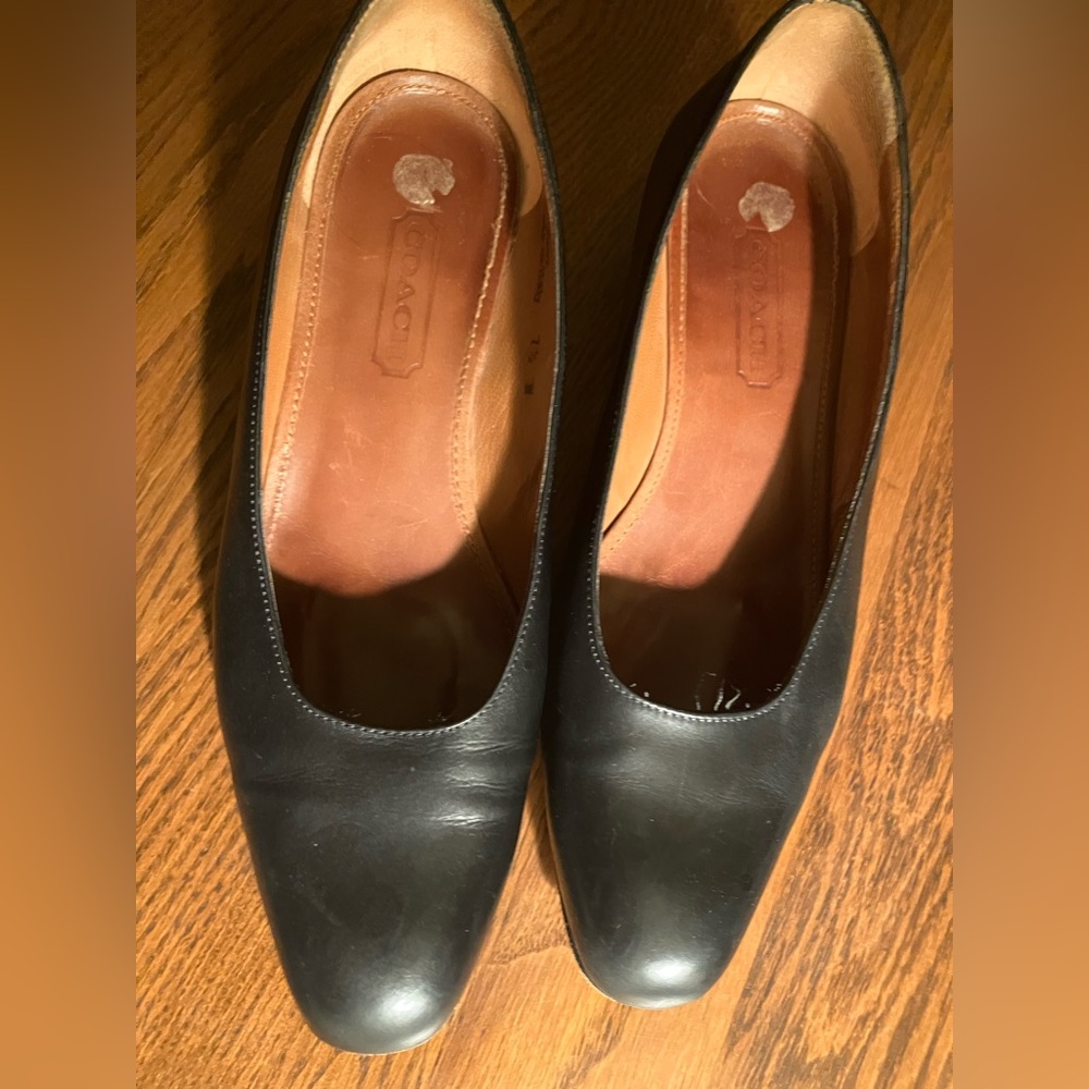 Coach pumps. Size 7 and 1/2. All leather black. Made/Italy.  Normal wear on sole